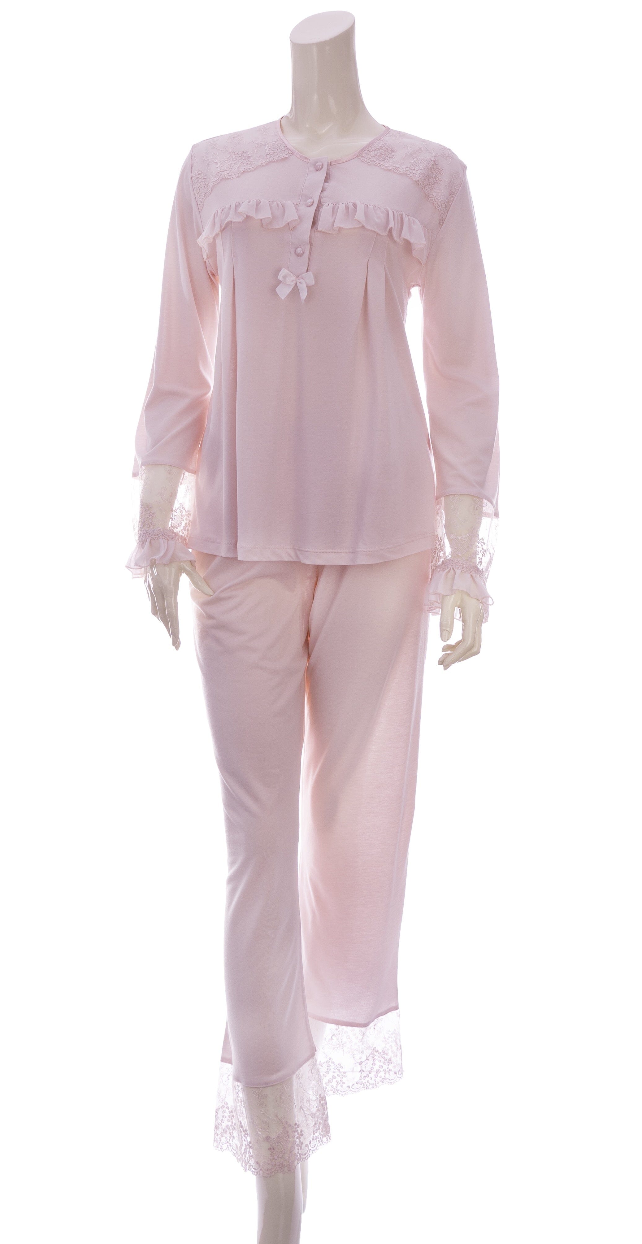 A pink pyjama set with lace trim, including a long-sleeve top with lace cuffs and pants with lace trim.