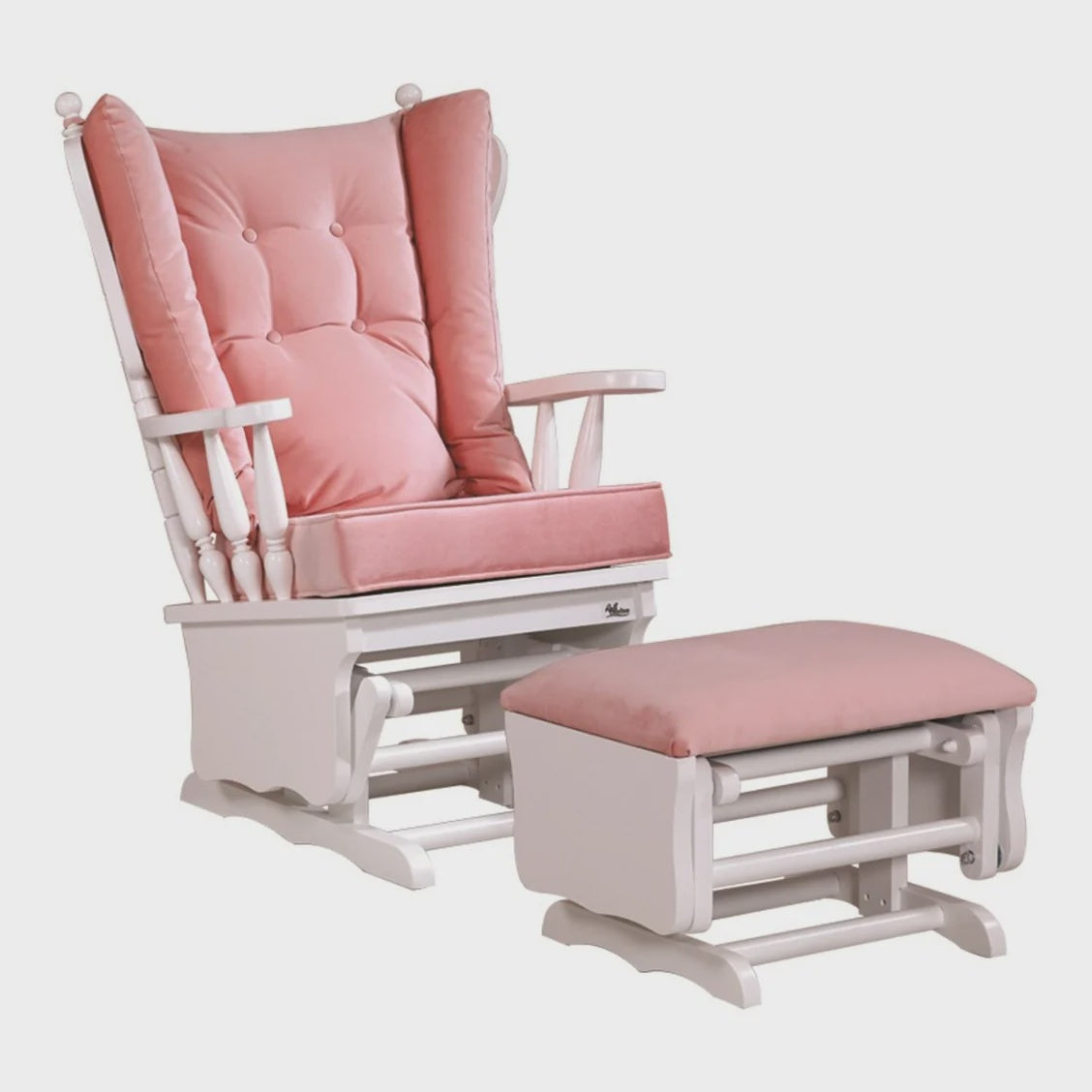 A white wooden rocking chair with a tufted pink cushion, shown with a matching white wooden glider and ottoman featuring a pink cushion.